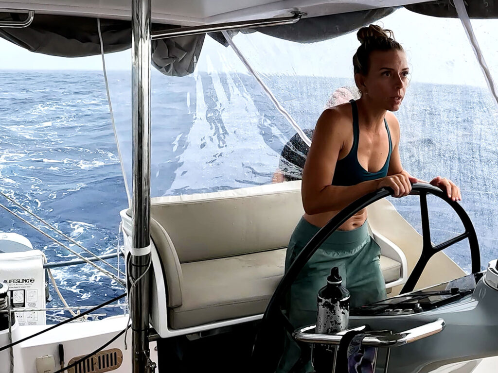 Kristin at helm sailing to Fatu Hiva