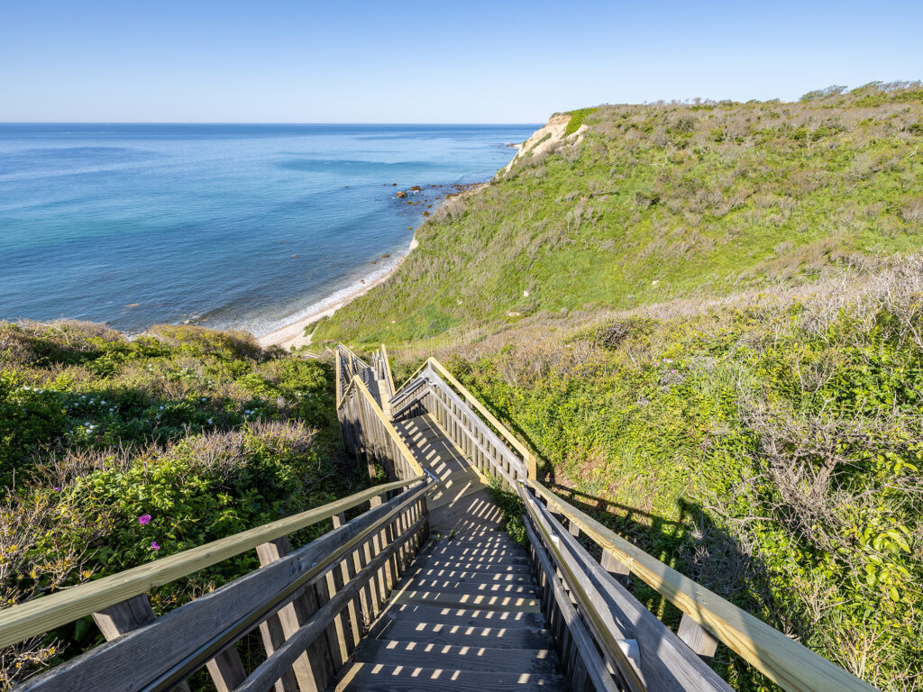 Long wooden staircase leading down to the beach at Mohegan Bluff