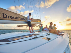 Passengers on a catamaran enjoying a sunset