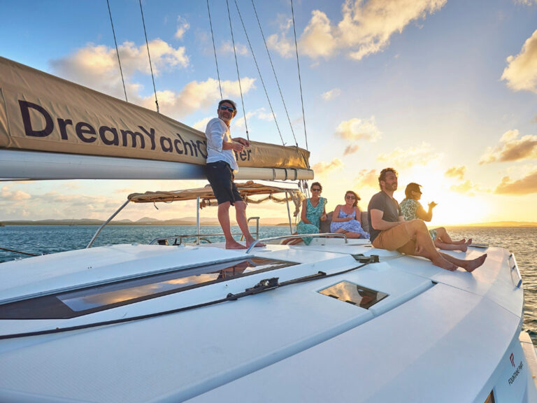 Passengers on a catamaran enjoying a sunset