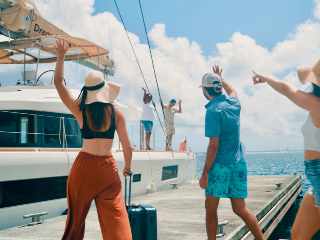 Guests greet a catamaran