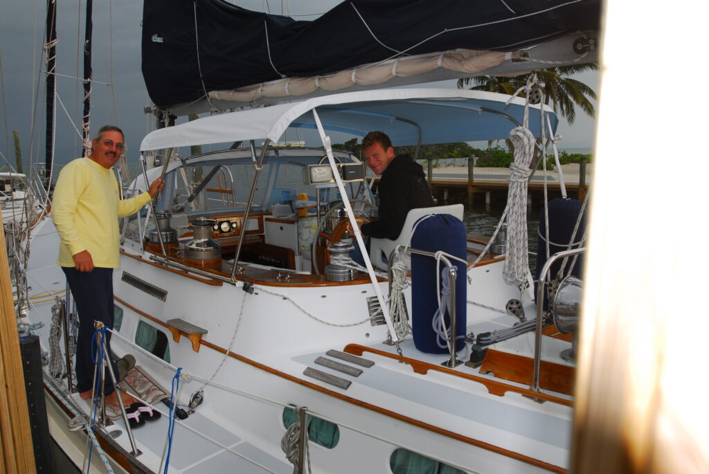 Two people on sailboat with cover attached