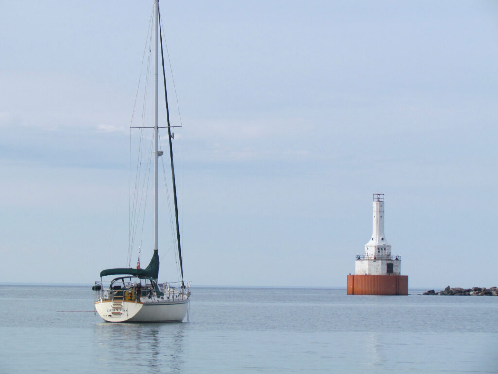 Sailboat near lighthouse