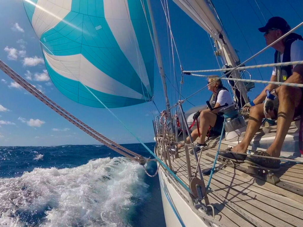 Two people on a sailboat in the Caribbean