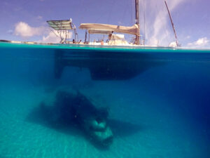 airplane underwater below a sailboat