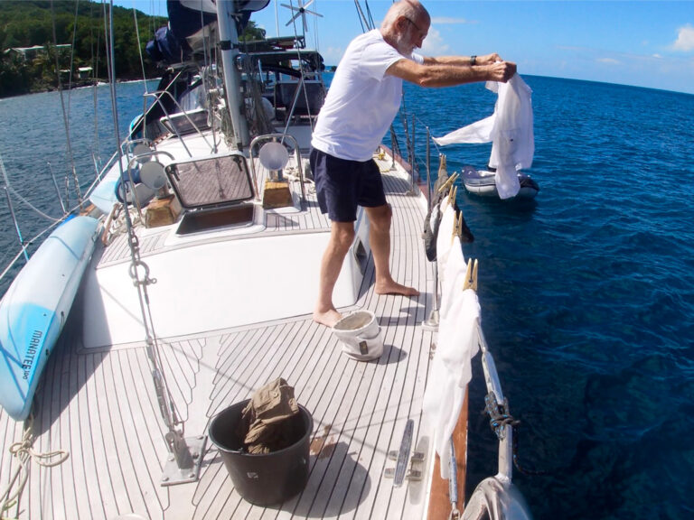 Hand washing clothes on a boat