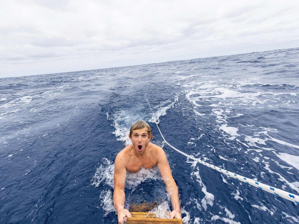 Man getting onto sailboat