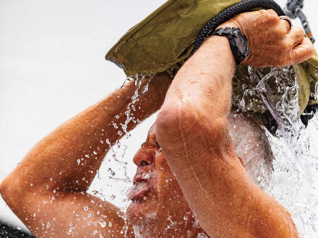 Man washing himself on sailboat