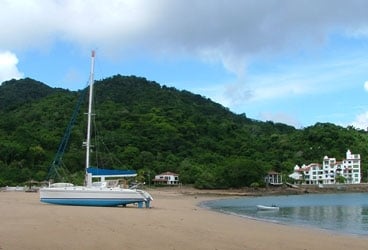 Beached Esprit de Tizza gets the royal careening treatment on a Panamanian beach.