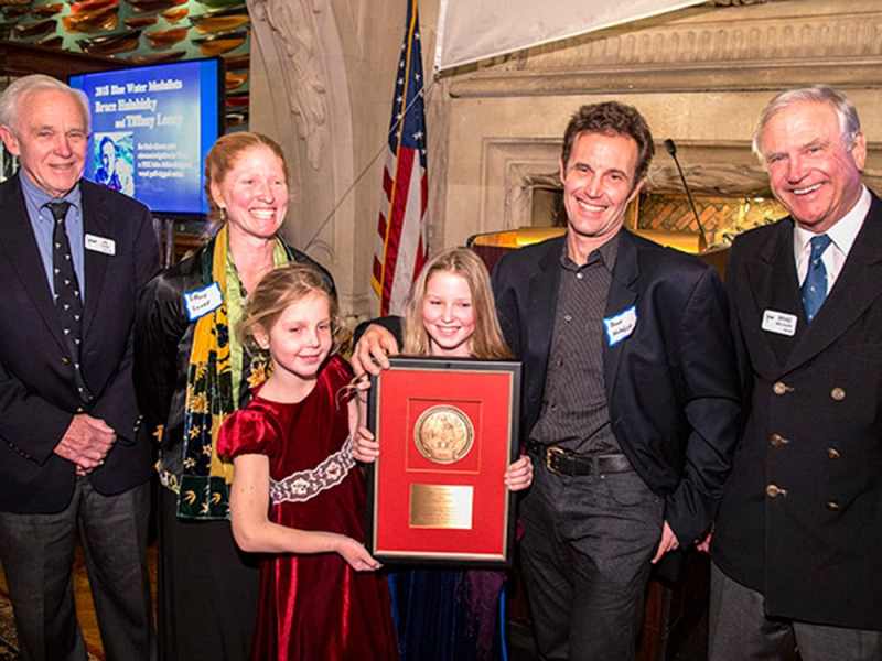 2018 CCA Award Winners    Photo © Dan NerneyThe 2018 CCA Blue Water Medalists  Tiffany Loney and Bruce Halabisky with their daughters Soliana and Seffa Jane receiving the Blue Water Medal from Awards Chairman Bill Cook and CCA Commodore Brad Willauer at the New York Yacht Club.