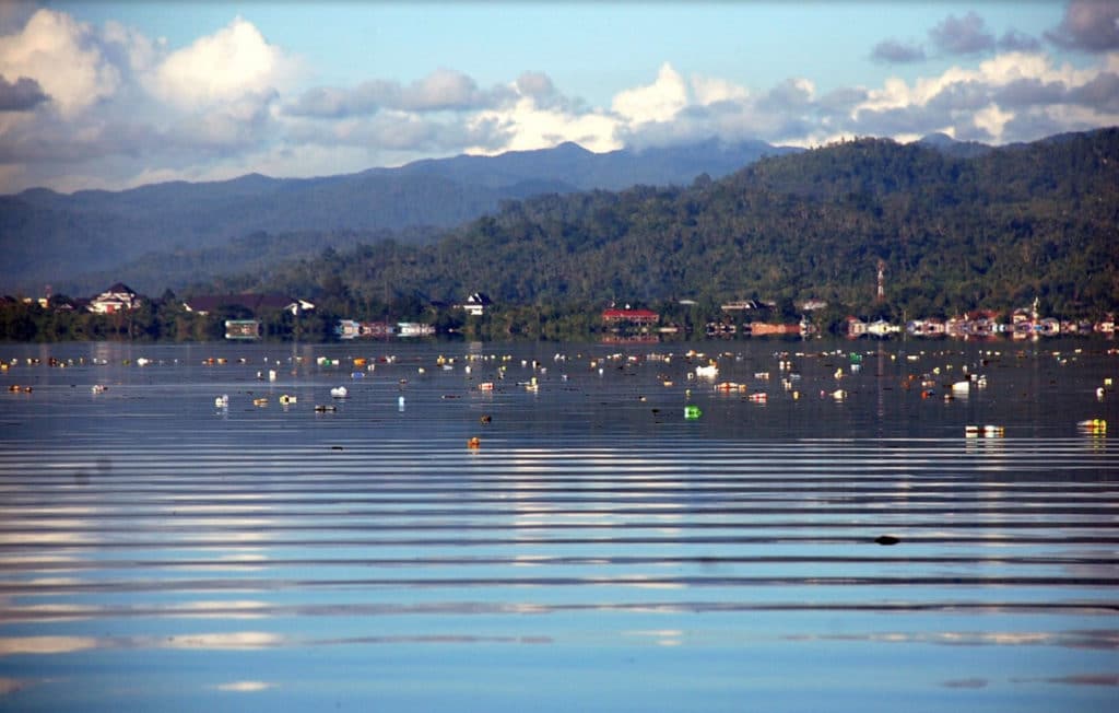 A wave of garbage arrives with the tide in Ambon, Indonesia