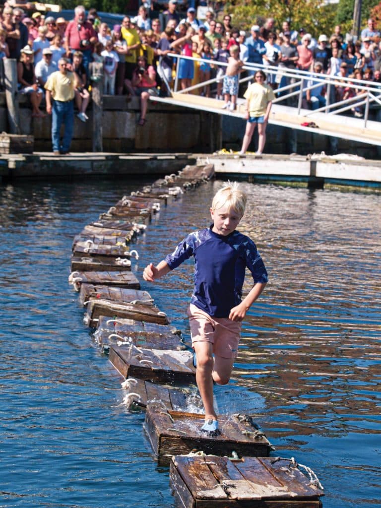 A boy running across lobster crates.