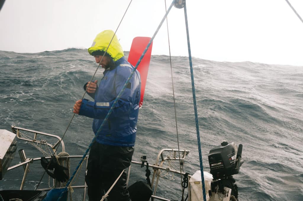 Tending to a sailboat during rough seas.