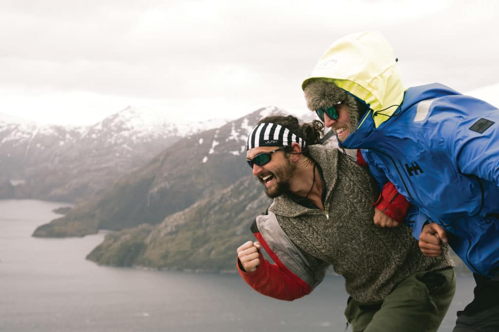 Two guys posing for a photo on a mountain.