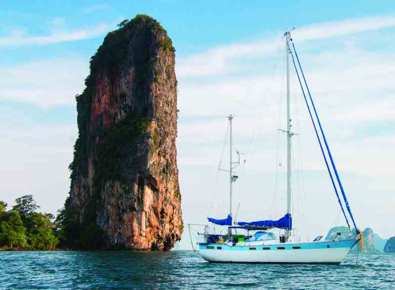 Ganesh, the Goodlanders' 43-foot Wauquiez Amphitrite ketch, anchors among the spectacular rock sculptures in Thailand's Phang Nga Bay.