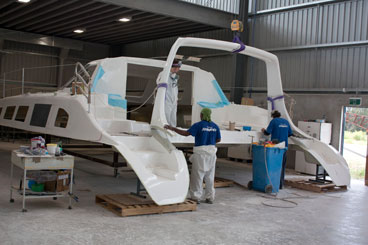 Seawind A worker at the Seawind Catamarans plant prepares to bond the arch to a hull.
