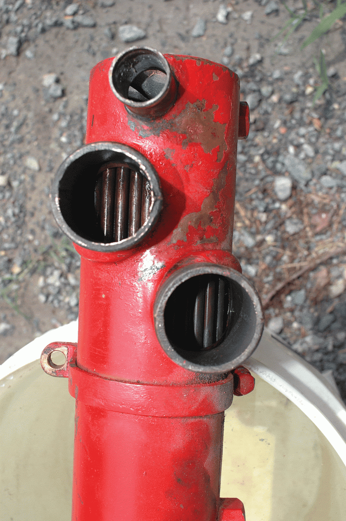 The tubes on the closed cooling side of this heat exchanger were fouled by a film that required solvent flushing, after which the change in color was clear to see.