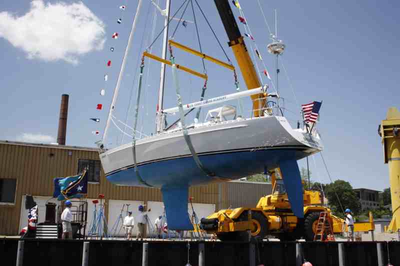 Shearwater, hull number 1 of the new Coast Guard Leadership 44s, is lifted by crane and positioned for its christening at the Coast Guard Academy in New London, Connecticut.