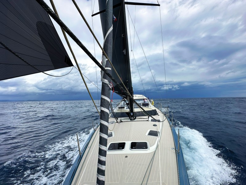 Sailboat departing the mainland
